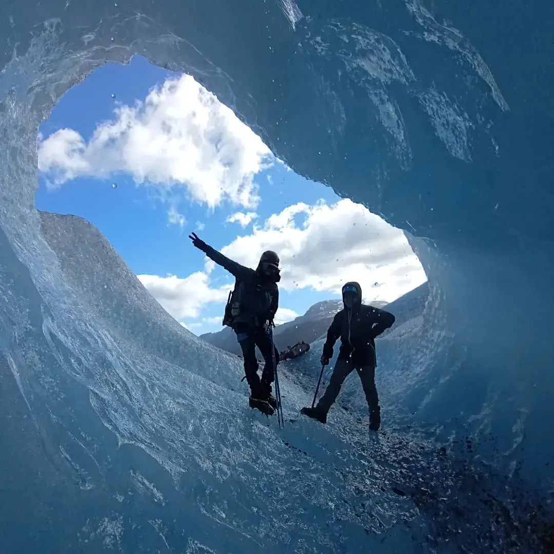 Dos personas dentro de una cueva de hielo en el Glaciar Exploradores
